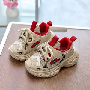 Detail of kids breathable mesh sneakers with red accents and non-slip thick rubber sole