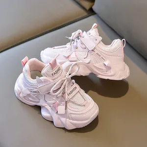 Detail of pink kids sneakers with mesh upper, Velcro strap and thick non-slip sole