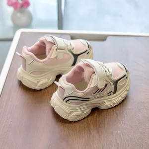 Detailed close-up of pink breathable mesh kids sneakers with Velcro straps and thick soles