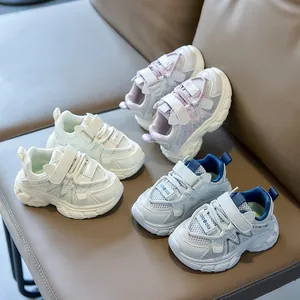 Kids breathable mesh sneakers with double velcro straps in three colors on a bench