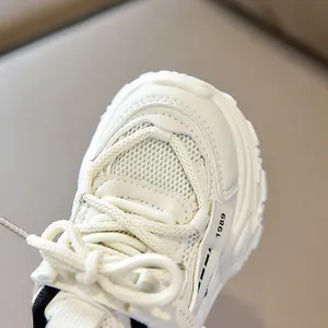 Detail of white mesh kids sneakers with 1989 tag and breathable synthetic leather
