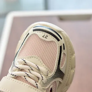 Close-up of children's sneaker featuring breathable mesh and number 27 printed on toe
