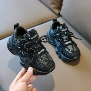 Close-up of black kids' fashion sneakers with mesh texture and glitter details