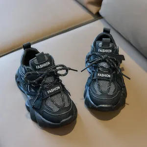 Detail of kids black chunky sneakers showing breathable mesh and velcro closure