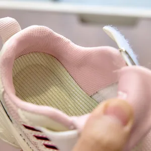 Detail view of pink mesh lining, anti-slip insole and velcro closure for kids sneakers