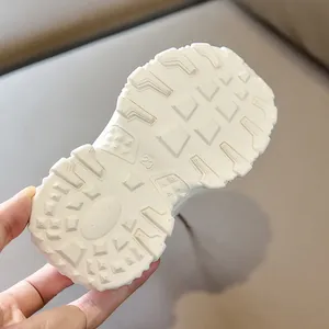 Macro detail of breathable kids sneaker outsole with non-slip geometric patterns