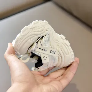 Close-up of flexible non-slip thick sole on breathable mesh kids sneakers in beige