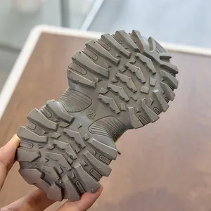 Detail of grey non-slip rubber sole with size 24 marking on kids sports shoes