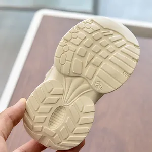 Detailed view of kids' sports shoes anti-slip rubber sole with size 23 engraving