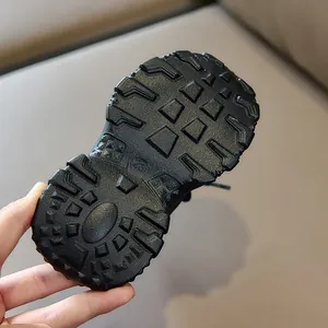 Close-up of children's sport shoe sole with size 23 and deep anti-slip geometric patterns
