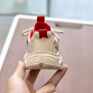 Detailed close-up of children's retro sneakers with beige mesh and soft rubber soles