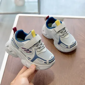 Detail of children's mesh sneaker featuring velcro strap and wavy non-slip white sole