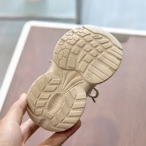 Close-up of beige toddler sneakers showing the non-slip thick EVA sole with size 23 detail