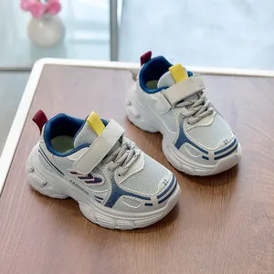 Detailed top view of breathable mesh kids sneakers with Velcro straps on wood background