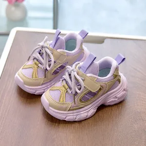 Detail showing breathable purple mesh upper and beige Velcro strap on kids' sneakers