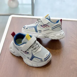 Close-up of kids' breathable mesh sneakers with velcro strap on a wooden background