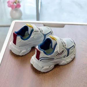 Detail view of breathable grey mesh kid's sneakers with blue accents and velcro strap