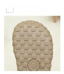Detailed view of the soft anti-slip rubber sole with texture and size 23 mark for kids