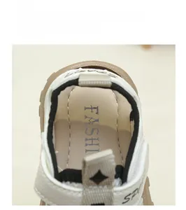 Detail of soft padded inner lining and heel pull tab of cream toddler sport sandals