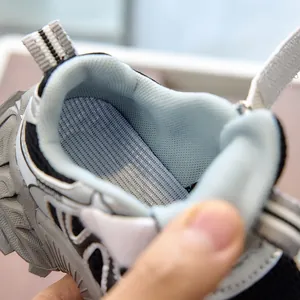 Detail shot of the breathable mesh lining and cushioned insole of kids sports shoes