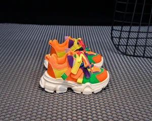 Macro shot of colorful chunky sneakers for kids with mesh texture and velcro strap