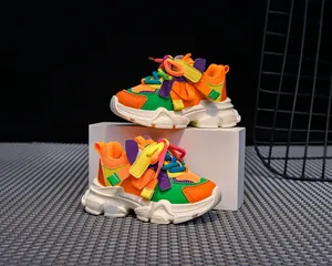 Detail view of colorful chunky kids sneakers with mesh fabric and velcro closure