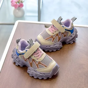 Detail of children's fashion sneaker with mesh fabric and thick jagged purple sole