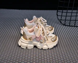 Detail view of girls' beige chunky sneakers with golden faux leather and mesh fabric