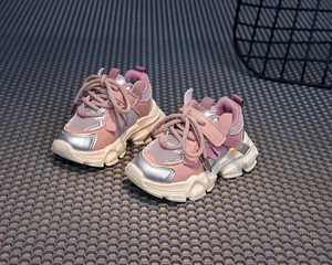 Detailed side view of pink children's sneakers with silver accents and mesh fabric