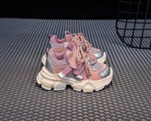 Detail of kids pink sneakers showing anti-slip thick soles and mesh leather texture