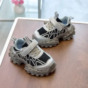 Detail of children's chunky sneaker showing breathable mesh, wavy overlays and Velcro strap