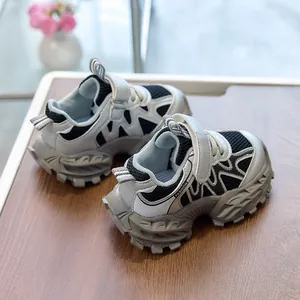 Detail of silver kids sports shoes with mesh panels and non-slip thick soles