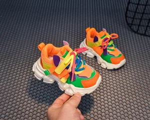 Detail of colorful chunky girls' sneakers featuring breathable mesh and velcro straps