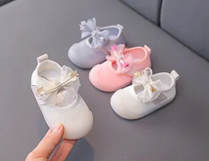 Close-up of baby Mary Jane shoes with mesh bows and sparkly star details