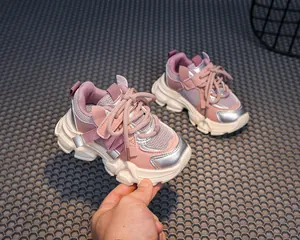 Detail of pink and silver mesh sneakers showing anti-slip thick soles and texture