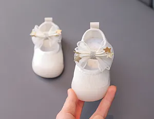Detail of baby girl shoes with breathable mesh bow and golden star rhinestone accents