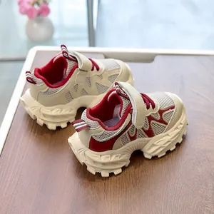 Macro view of breathable beige mesh and burgundy details on kids sneaker with velcro strap