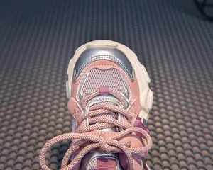 Detailed top view of pink girl's chunky sneaker showing mesh texture and silver accents