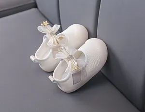Detailed macro view of baby walking shoes with mesh fabric bow and star accents