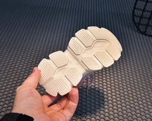 Detailed view of the durable cream rubber sole with geometric anti-slip pattern and size 23