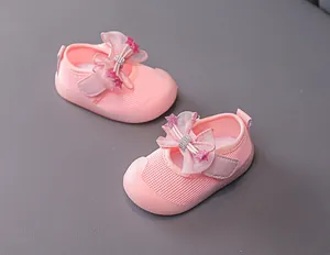 Detail of pink toddler shoes showing breathable mesh fabric and a decorative bow