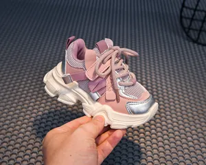 Detailed close-up of kids sneakers with pink mesh fabric and velcro strap