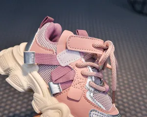 Detail of pink and purple children sneakers with breathable mesh and velcro strap