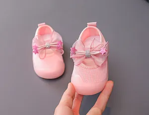 Detail of pink toddler shoes with mesh fabric and large decorative mesh bow on the toe