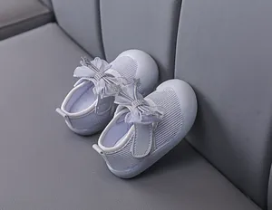 Detail of baby girl toddler shoes featuring purple mesh, big bow, and sequin stars