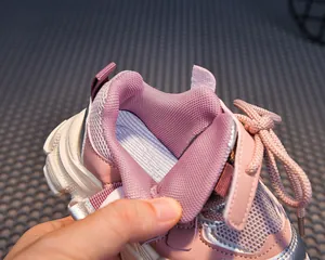 Detail of pink kids sports sneaker showing mesh lining and breathable purple insole texture
