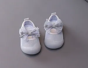 Close-up of breathable mesh baby girl shoes with bow decoration and rhinestone detail