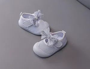 Detail of light purple baby walking shoes with tulle bow, star rhinestones and mesh fabric