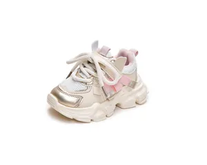 Detail of girls' chunky sneakers featuring breathable mesh and pink ribbon accents