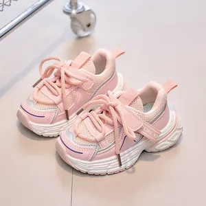 Detailed close-up of pink breathable mesh fabric and durable sole on children's sneakers